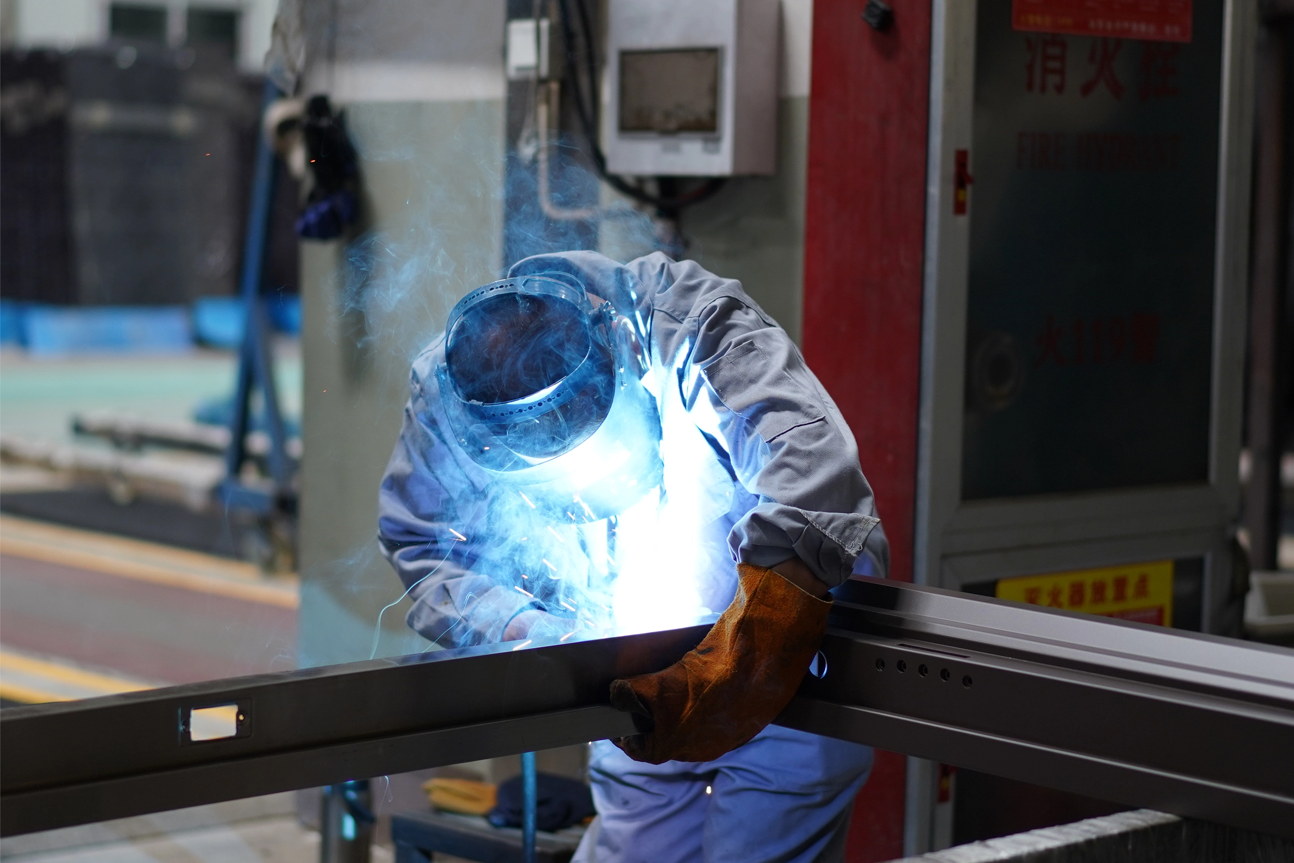 Worker welding metal frame components