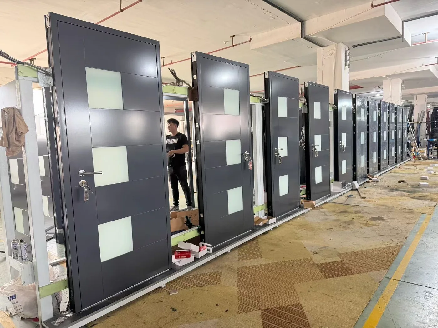 JMR factory worker assembling smart entrance door hardware into a custom door system